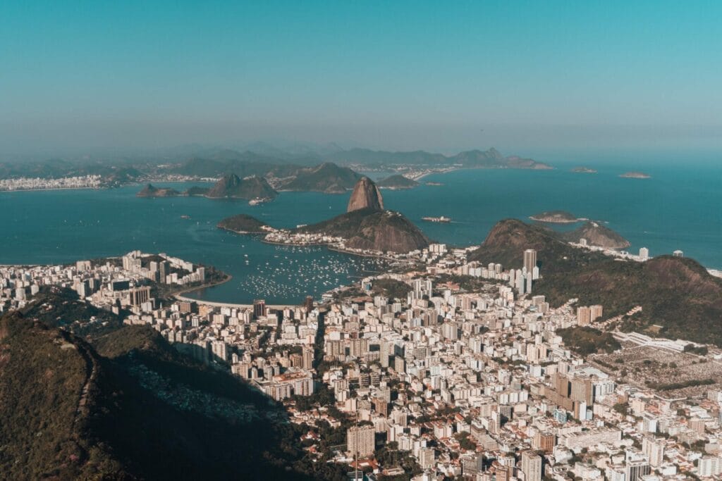 Aerial view of Rio de Janeiro with Sugarloaf Mountain and Guanabara Bay on a clear, sunny day.